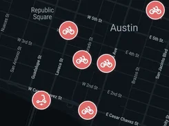 Mobile rider-app map of central Austin with available bicycle and scooter markers and a “Scan to Ride” button.