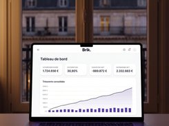 Brik dashboard on a laptop showing rent collected, occupancy, cash flow, net assets, and a consolidated cash chart.
