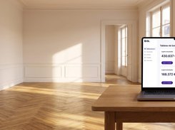Brik dashboard displayed on a laptop in an empty apartment, with rent and occupancy widgets.