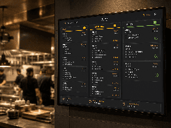 A wall-mounted kitchen display shows restaurant orders arranged in New, Preparing, and Ready columns, with preparation-time summaries.
