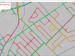 Flokon map view displaying a street network overlaid with green, red, yellow, and purple route-status lines.