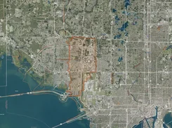 Satellite map of Tampa with roads, waterways, and a broad orange outlined area.