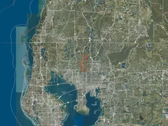 Satellite map of the Tampa Bay area with roads, municipal boundary lines, and an orange outlined region.