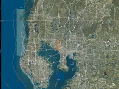 Satellite map of the Tampa Bay area with roads, water, and an orange outlined region north of the bay.