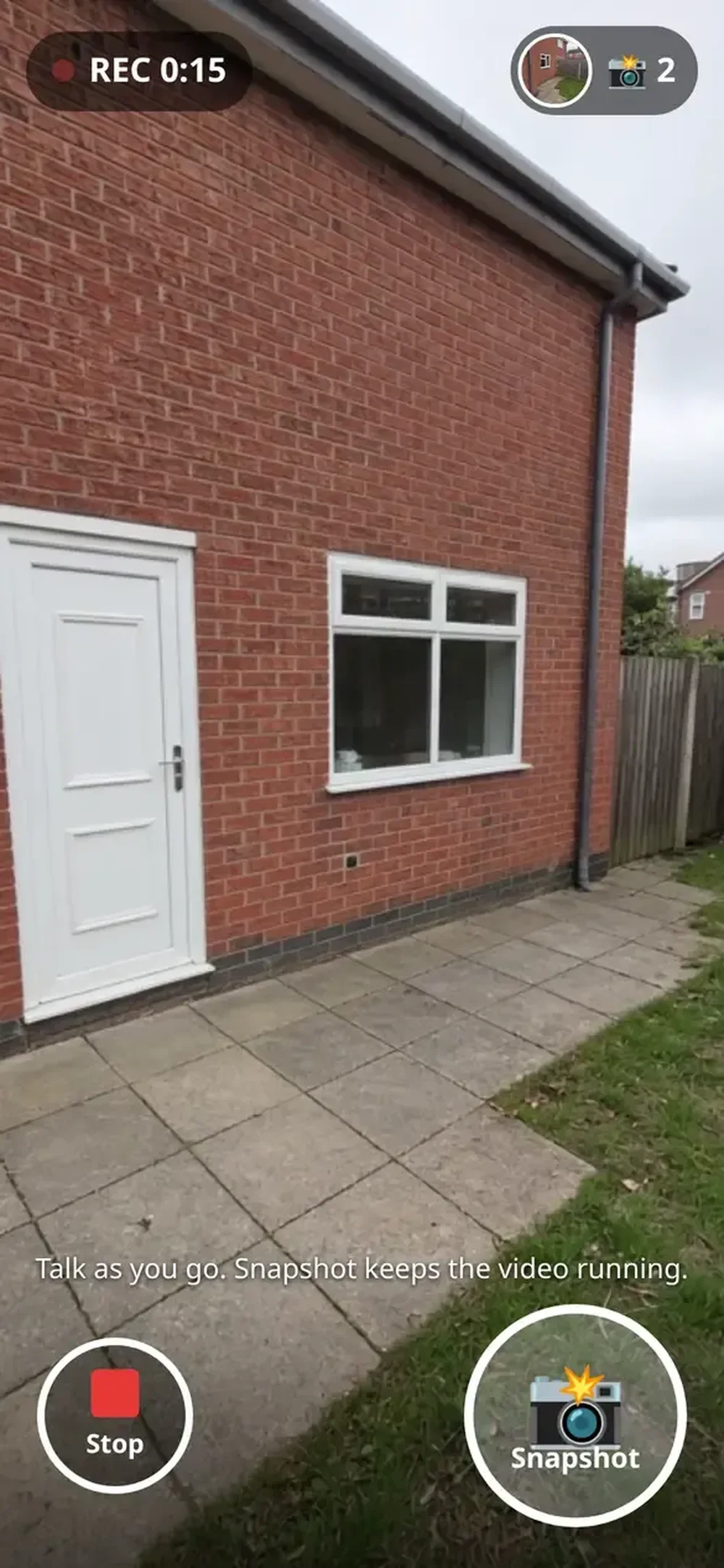 Mobile camera-recording interface over a view of a brick house wall, door, window, and patio, with recording timer, Stop, and Snapshot controls.