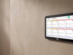 A wall-mounted Kayana touchscreen displays a grid of color-coded pending kitchen orders.