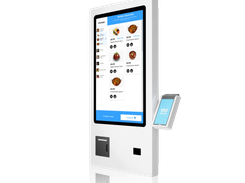 A white freestanding self-service kiosk displays a food menu with item photos and a Kayana-branded payment screen on its side.