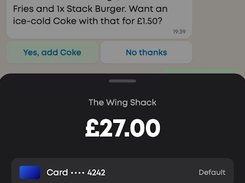 Mobile payment sheet for The Wing Shack showing a £27.00 charge and a masked card ending in 4242, over a chat-based upsell prompt.