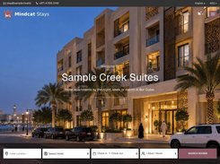 Mindcat Stays booking site for Sample Creek Suites, hotel apartments by the night, week or month in Bur Dubai, with a dusk photo of the building and a search bar for hotel location, hotel, check-in and check-out dates and guests.