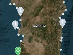 Nautilum Atlas mobile map showing Sardinia with anchor-shaped location pins, filters, search, and bottom navigation.