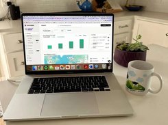 Photo of a MacBook displaying an Outfame Growth analytics dashboard with follower metrics, bar charts, map, and activity panel.