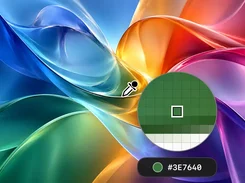 A colorful abstract image is shown with an eyedropper cursor, a circular pixel magnifier, and a selected green color labeled #3E7640.
