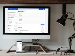 Desktop monitor and phone mockups display Stock Alarm market screener and scan interfaces on a desk.