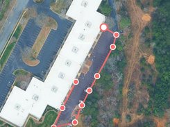 Mobile SurfaceMeasure interface with red points and lines tracing a parking lot and a green Done button.