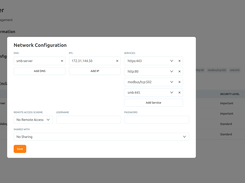 Access Gate asset-management screen with a Network Configuration dialog for an SMB Server, including DNS, IP address, services, remote-access scheme, and sharing fields.