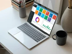 Softpal warehouse dashboard displayed on a laptop, with order metrics and charts.