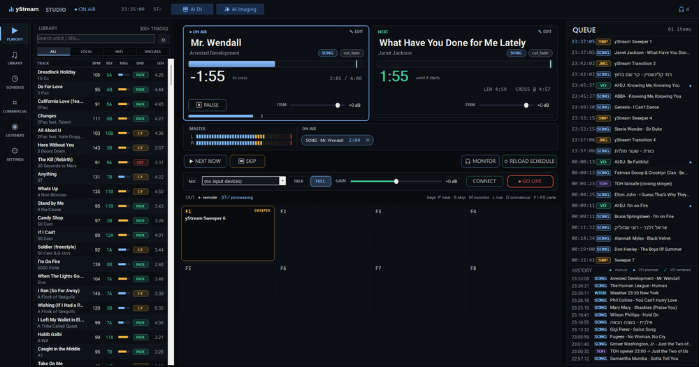The whole station on one screen: two decks, the queue the AI editor built, cart wall and a live mic, with the AI DJ on.